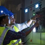 Engineers are checking electronic system at basement.