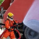 Fireman wearing fire protection suite and oxygen tank exercise h